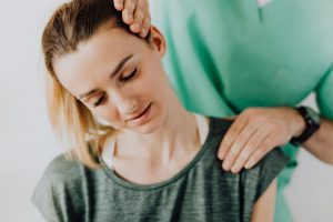 Canva - Crop massage therapist rubbing patients neck